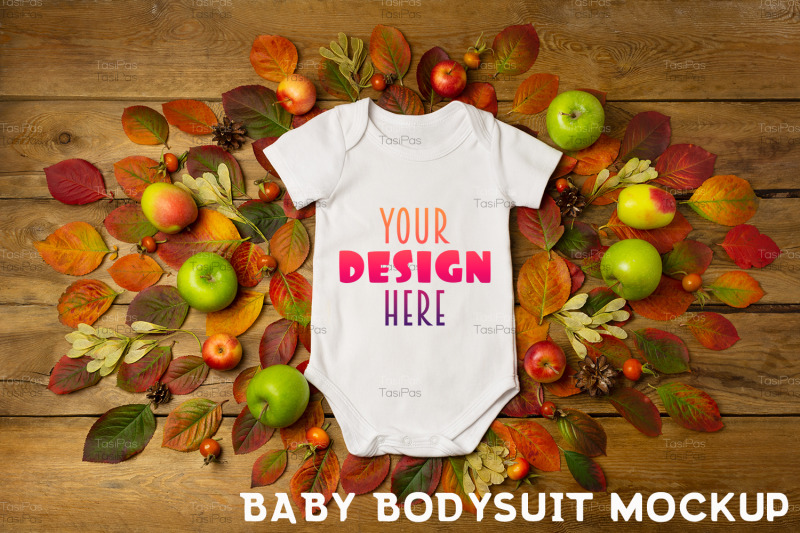 white-baby-short-sleeve-bodysuit-mockup-with-fall-leaves-and-pine-cone