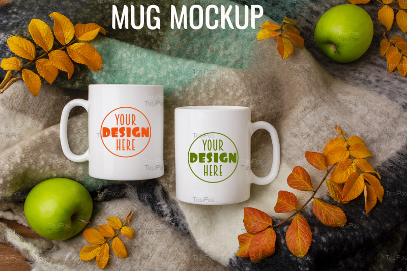 two-white-coffee-mug-mockup-with-woolen-scarf-apples-and-fall-leaves