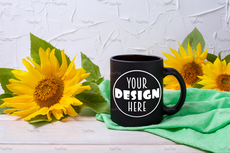 black-coffee-mug-mockup-with-green-napkin-and-sunflowers