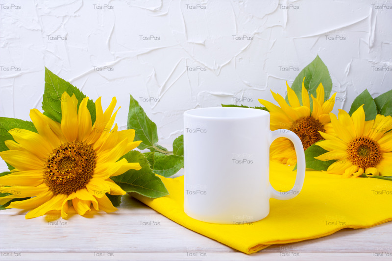 white-coffee-mug-mockup-with-yellow-sunflowers-and-napkin