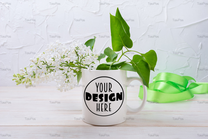 white-coffee-mug-mockup-with-green-ribbon-and-white-lilac