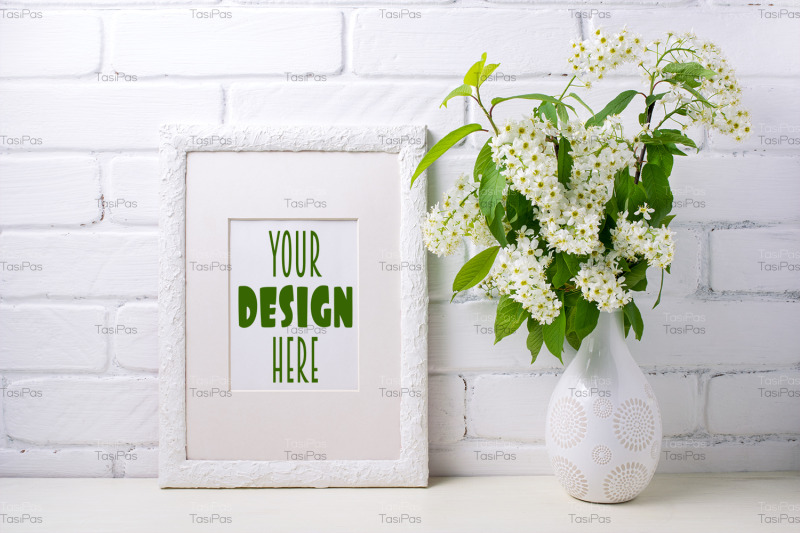 white-frame-mockup-with-blooming-bird-cherry-in-the-decorated-vase