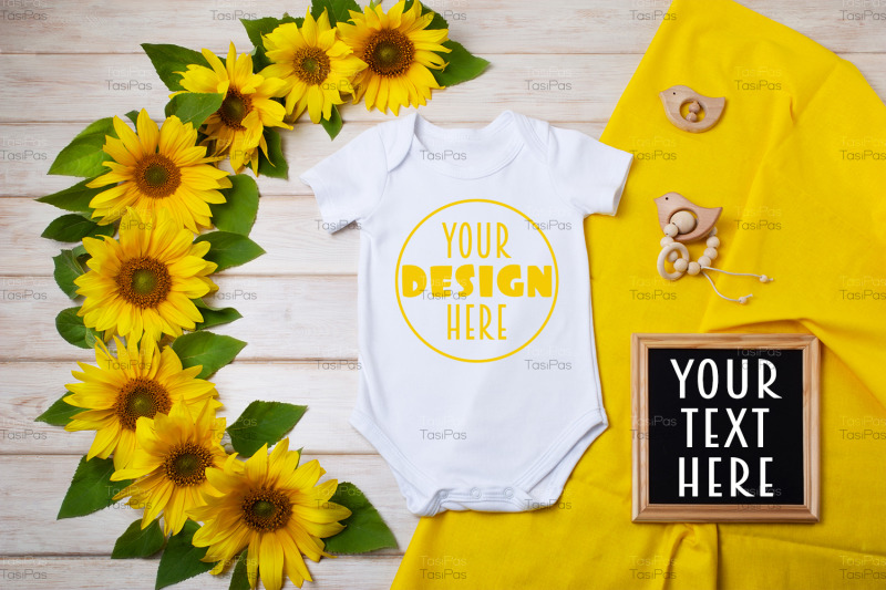 white-baby-short-sleeve-bodysuit-mockup-with-sunflowers-and-black-chal
