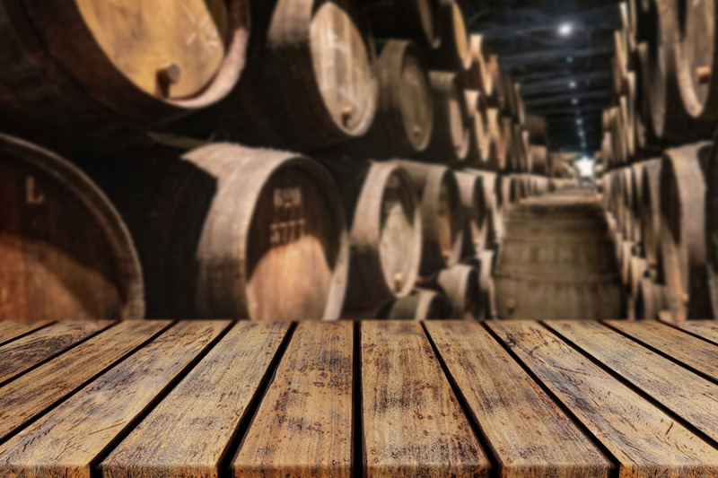 empty-brown-table-old-rustic-wood-plank-with-blurred-old-wine-cellar
