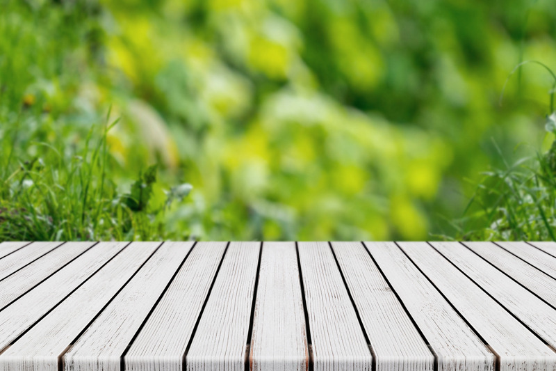 empty-white-plank-wood-table-with-bokeh-green-foliage-background