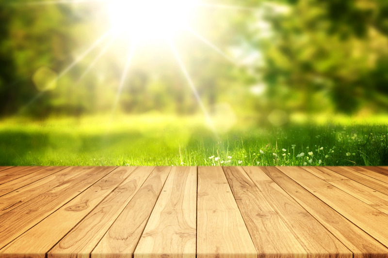 empty-wood-plank-table-with-blurred-green-bokeh-sunlight-background