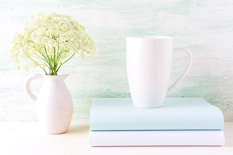 white-cappuccino-mug-mockup-with-wild-meadow-flowers-in-pitcher