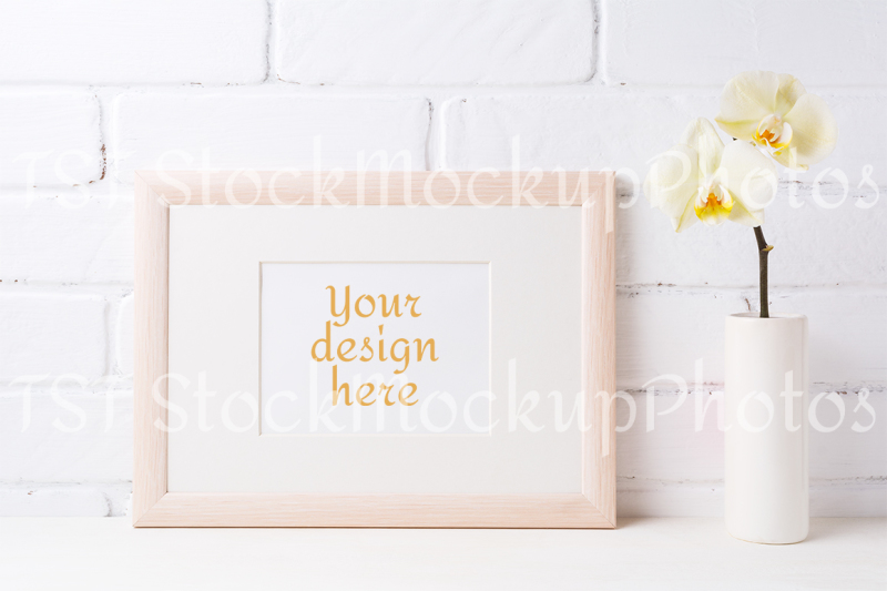 wooden-landscape-frame-mockup-with-soft-yellow-orchid-in-vase